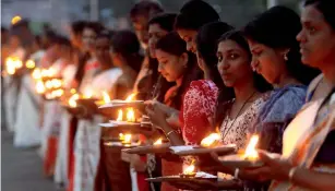  ?? PTI ?? People take part in the ‘Ayyappa Jyothi’ campaign (lighting of lamp) in Kottayam district of Kerala. —