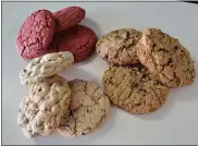  ??  ?? The Behemoth chocolate chip, right, Oatmeal Raisin the Dead and, coming soon, a red velvet confection, left, are among the varieties currently offered by Monster Cookies.