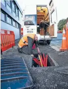  ??  ?? On a roll: A Transfield technican working on the UFB rollout which National may consider extending to more towns.