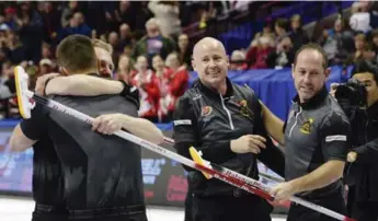  ?? ADRIAN WYLD/THE CANADIAN PRESS ?? Kevin Koe, centre, will be a first-time Olympian at the Pyeongchan­g Games in February. Lead Ben Hebert, left, and third Marc Kennedy won Olympic gold in 2010, while second Brent Laing, right, is also a newcomer.