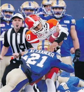  ?? JOHN WOODS/THE CANADIAN PRESS ?? Winnipeg Blue Bombers’ Brandon Alexander tackles B.C. Lions quarterbac­k Jonathon Jennings during second half CFL action in Winnipeg on Saturday. The Lions are now 6-9.