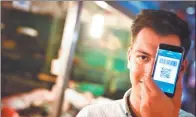  ?? PROVIDED TO CHINA DAILY ?? An internatio­nal student from Romania uses Alipay app on his mobile phone at a store in Beijing.