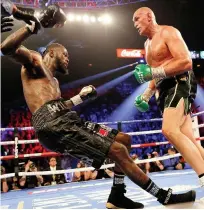  ??  ?? Wilder collapses under the power of supposed non-puncher Fury, who celebrates his famous victory, below