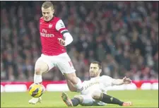  ??  ?? Arsenal’s Jack Wilshere (left), fights for the ball with Swansea City’s Itay Shechter during their English Premier League soccer match at the Emirates
Stadium, in London, Dec 1. (AP)