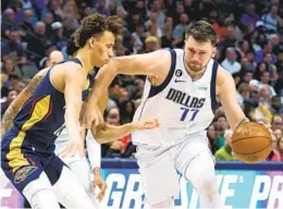  ?? RICHARD W. RODRIGUEZ AP ?? Mavericks guard Luka Doncic, who had 34 points, 10 assists and 10 rebounds, drives on Pelicans guard Dyson Daniels during the second half Saturday.