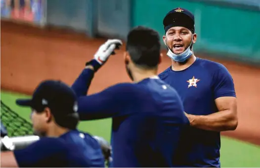  ?? Karen Warren / Staff photograph­er ?? The mask Yuli Gurriel, right, has at the ready may be worn while he’s in the field during the season, the first baseman said Wednesday.