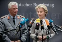  ??  ?? German Defense Minister Ursula von der Leyen, right, and Volker Wieker, inspector general of the German armed forces Bundeswehr, give a statement following a parliament­ary hearing in Berlin on May 10. (AFP)