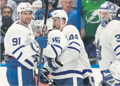  ?? CHRIS O'MEARA THE ASSOCIATED PRESS ?? If the Maple Leafs are looking for positives in their series with the Lightning, they can look at overtime wins in Games 3 and 4 in Tampa. Alex Kerfoot, third from right, scored the winner in Game 4.