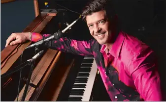  ?? CHRIS PIZZELLO/AP PHOTO ?? Singer/songwriter Robin Thicke poses for a portrait at Gold Diggers Sound in Los Angeles to promote his eighth album, “On Earth, and In Heaven.”