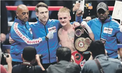  ?? Picture: Getty Images ?? TRIPLE CHAMPION. Hekkie Budler and his management team celebrate his points victory over Ryoichi Taguchi in Tokyo at the weekend.