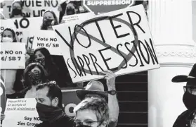  ?? Eric Gay / Associated Press ?? The elections bill includes limitation of early-voting hours and bans on drive-thru voting, mail ballot drop boxes and mass mailing of mail ballot applicatio­ns.