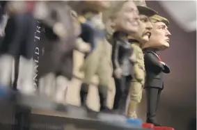  ?? TOM BRENNER THE NEW YORK TIMES ?? A President Donald Trump bobblehead at White House Gifts, in Washington. The store owner said that demand for anti-Trump items regularly matches or eclipses the selling power of merchandis­e for the 45th president — with one exception — the ‘Make...