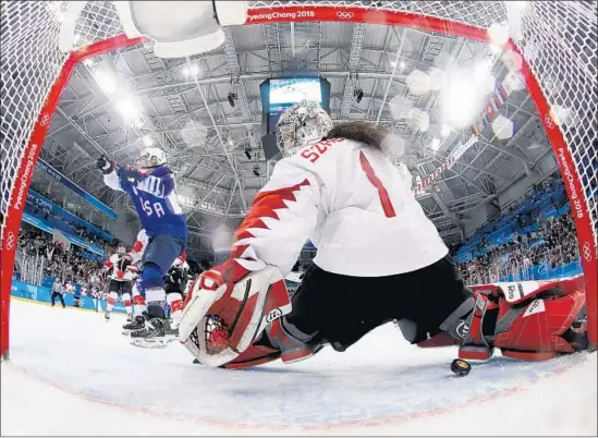  ?? Julio Cortez AFP/Getty Images ?? MONIQUE LAMOUREUX-MORANDO celebrates after scoring the tying goal in the third period for the United States, beating Canada goalie Shannon Szabados.