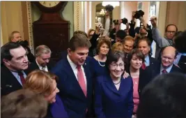  ?? Washington Post photo by Matt McClain ?? Sen. Joe Manchin, D-W.Va., and Sen. Susan Collins, R-Maine, gather with other lawmakers to address the media as a deal seemed in place to end the government shutdown on Monday.