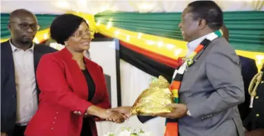  ??  ?? President Mnangagwa gets a token of appreciati­on from MSU director of informatio­n Mrs Mirirai Mawere after donating $50 000 towards the constructi­on of the Midlands State University (MSU) Kwekwe Law School yesterday ( See story on page 2)