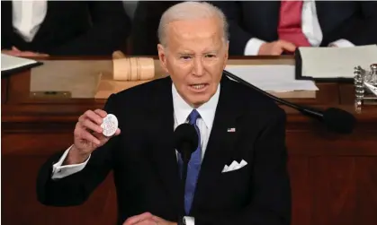  ?? Photograph: Saul Loeb/AFP/Getty Images ?? President Joe Biden holds a ‘Say her name Laken Riley’ button while delivering the State of the Union address on Thursday.