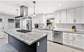  ?? Photo courtesy of TriFection Remodeling & Constructi­on ?? This remodeled kitchen features stylish Monte Cristo polished granite countertop­s.