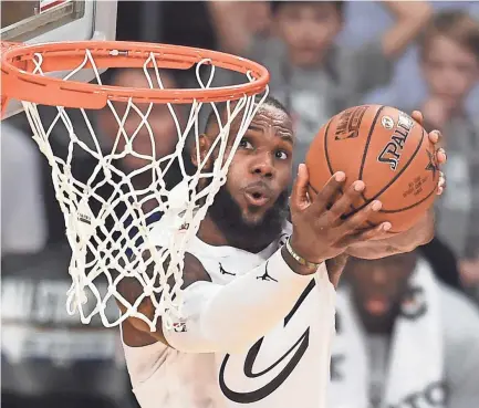  ??  ?? LeBron James and his new Los Angeles Lakers teammates will visit defending champion Golden State on Christmas in a 2018-19 NBA season that opens Oct.16. ROBYN BECK/AFP/GETTY IMAGES