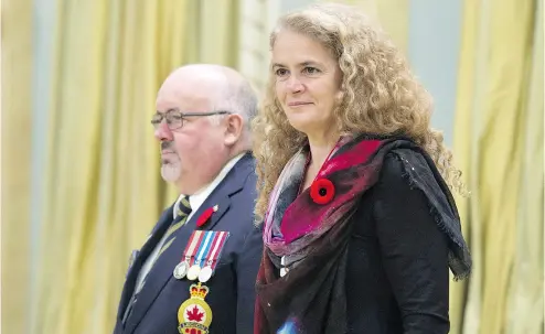  ?? ADRIAN WYLD / THE CANADIAN PRESS ?? Gov. Gen. Julie Payette, standing with the Legion’s Dominion president David Flannigan, ruffled some feathers after she used a speech at an Ottawa policy convention Thursday to criticize climate change denial and creationis­m.