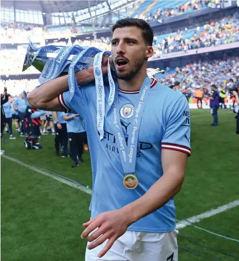  ?? Getty Images ?? Manchester City defender Ruben Dias with the Premier League trophy after last season’s title win