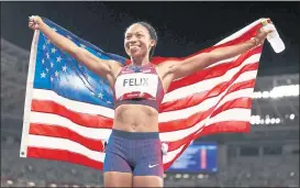  ?? DAVID RAMOS — GETTY IMAGES ?? Team USA’s Allyson Felix holds up a U.S. flag after winning the bronze medal in the women’s 400-meter event on Friday in the Tokyo Olympic Games at Olympic Stadium.