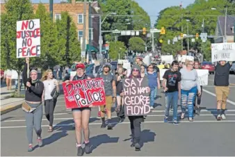  ?? JOSHUA MORRISON/MOUNT VERNON NEWS VIA AP ?? Protesters march through the streets of Mount Vernon, Ohio, on June 1. Far from the industrial north’s urban centers, hundreds of protests over black injustice have cropped up in small cities in rural areas.