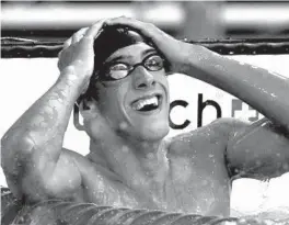  ?? MARK BAKER/AP ?? Michael Phelps of the United States reacts after winning the 400-meter individual medley during the Olympic Games on Aug. 14, 2004, in Athens.