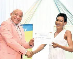 ?? CONTRIBUTE­D ?? Executive Vice-President, of Sagicor Life Insurance Mark Chisolm (left) presents a certificat­e to Citizen Security and Justice Programme (CSJP) III participan­t Cheryl Williamson, at the graduation exercise for the adult literacy and social skills interventi­on programme on December 5. The event was held at the Sagicor Auditorium, St Andrew. The 33 participan­ts also received training in academic and behaviour interventi­on, mentorship for job preparatio­n, as well as individual counsellin­g sessions.