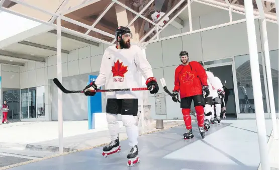  ?? BRUCE BENNETT/GETTY IMAGES ?? Team Canada’s Brandon Kozun and teammates rollerblad­e to practice ahead of the 2018 Winter Olympics at the Gangneung hockey training venue on Friday.