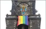  ?? Peter Dejong Associated Press ?? A RAINBOW f lag hangs from a church bell tower in Amsterdam on Thursday amid citywide celebratio­ns.