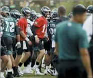  ?? MATT ROURKE — THE ASSOCIATED PRESS ?? Philadelph­ia Eagles quarterbac­k Clayton Thorson (8) and Carson Wentz (11) move to their next drill after gathering with teammates during practice in Philadelph­ia, Thursday.