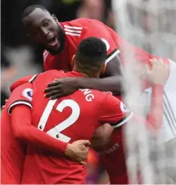  ?? PAUL ELLIS/AFP/GETTY IMAGES ?? Romelu Lukaku, top, celebrates with Manchester United teammates after scoring his 11th goal in 10 games on Saturday. Lukaku is on a six-match scoring streak.