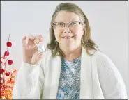  ?? (NWA Democrat-Gazette/Susan Holland) ?? Dorothy Hadley, a science teacher at Gravette Upper Elementary School, displays an owl pellet used by her fifth-grade science students to study food chains and ecosystems. Students analyzed the pellets to determine what the owls had eaten. Hadley received a Superinten­dent’s Grant award to help with funding and attended the Gravette School Board meeting to tell about the project.