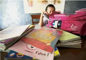 ??  ?? Caught in the middle: Experts believe being overwhelme­d with homework can have a negative impact on pupils.