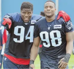  ?? STAFF PHOTO BY CHRIS CHRISTO ?? POINTING THE WAY: New Patriots defensive end Kony Ealy (left) shares a moment with Trey Flowers as they approach fans to sign autographs yesterday in Foxboro.