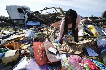  ?? JULIO CORTEZ — THE ASSOCIATED PRESS ?? Kimberly Patton sorts through belongings at the spot of a family member’s home Sunday in the aftermath of a tornado in Rolling Fork, Miss.