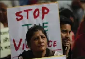  ?? RAJESH KUMAR SINGH — THE ASSOCIATED PRESS ?? Activists from different organizati­ons hold banners calling for peace and communal harmony following violence in New Delhi, India on Wednesday.