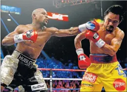  ?? Picture: GETTY IMAGES ?? REMATCH, PERHAPS: Floyd Mayweather, left, and Manny Pacquiao during their welterweig­ht unificatio­n championsh­ip bout in May last year