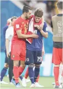  ??  ?? Belgium's Nacer Chadli, left, comforts Japan's Hiroki Sakai at the end of the round of 16 match between Belgium and Japan at the 2018 FIFA World Cup in the Rostov Arena, in Rostov-on-Don, Russia Monday. Belgium won 3-2. (AP)