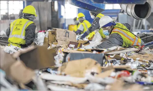  ?? L.E. Baskow Las Vegas Review-Journal @Left_Eye_Images ?? Workers pull out nonrecycla­ble materials at the Republic Services recycling center in North Las Vegas.