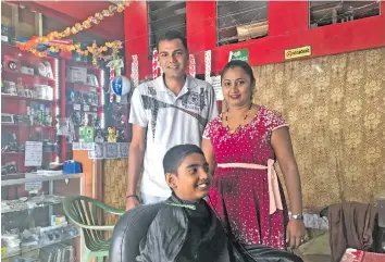  ?? Photo: Lusiana Banuve ?? Avinesh and Sheetal Singh (standing) inside their shop in Rakiraki town.