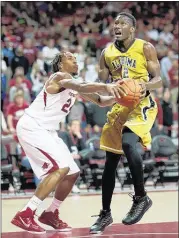  ?? SARAH BENTHAM / ASSOCIATED PRESS ?? Alabama State’s Maurice Strong, who had 11 points, rebounds ahead of Arkansas’ Michael Qualls in the first half Sunday in Fayettevil­le, Ark. The Razorbacks won, 97-79.