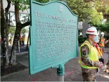 ?? (Photo by U.S. Army Corps of Engineers) ?? Workers stand by a sign explaining the building’s history.