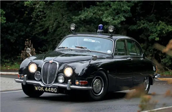  ??  ?? From top: Jag looks as if it has just roared off the set of Robbery; interior retains all its police accessorie­s; 220bhp, 3.8-litre twin-cam ‘six’ gave the hefty S-type a 116mph top speed