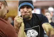  ?? Yi-Chin Lee / Houston Chronicle ?? Bradley Blackwell shows his intensity during his arm wrestling match with Derek Grimm on Saturday.