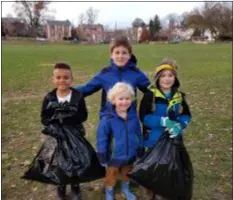  ?? SUBMITTED PHOTO ?? The Bear den from Cub Scout Pack 63, Lansdowne, did a clean-up at the playing fields next to Ardmore Avenue Elementary School in the William Penn School District. They collected three large bags of trash. Those who participat­ed in the clean-up at the Ardmore Elementary School playing fields included, left to right, scouts John Marks, Colin Burke, Graham Ryan, and, in front, Colin’s little brother, William Burke.