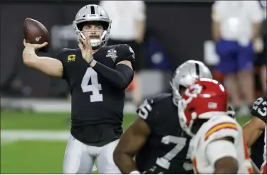  ?? ISAAC BREKKEN — THE ASSOCIATED PRESS ?? Las Vegas Raiders quarterbac­k Derek Carr, left, throws during Sunday’s loss to the Kansas City Chiefs. With stadiums nearly empty this season, Carr and other quarterbac­ks have come up with creative audibles to keep others on their toes.