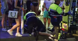  ??  ?? Emergency: Paramedics treat Cameron Relf as he lies in a stupor in the street
