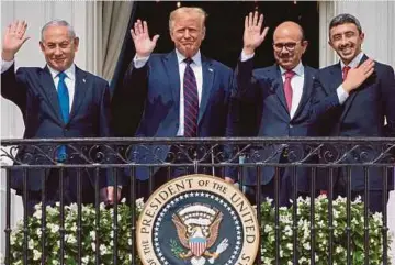  ?? AFP PIC ?? (From left) Israeli Prime Minister Benjamin Netanyahu, United States President Donald Trump, Bahrain Foreign Minister Abdullatif alZayani and United Arab Emirates Foreign Minister Abdullah bin Zayed Al-Nahyan waving from the Truman Balcony at the White House in Washington, D.C. on Tuesday.