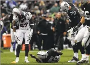  ?? JOSE CARLOS FAJARDO — STAFF PHOTOGRAPH­ER ?? Amari Cooper lies on the ground after being knocked cold on a hit by Denver safety Darian Stewart in the second quarter.